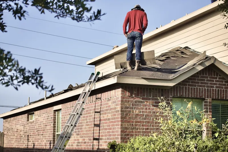 Professional roofer working on a residential roof in Starsdale Manor